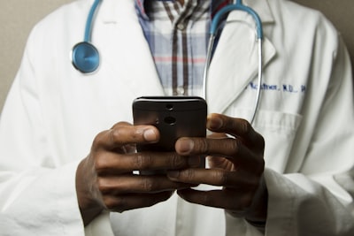 Doctor responding to a message on mobile device